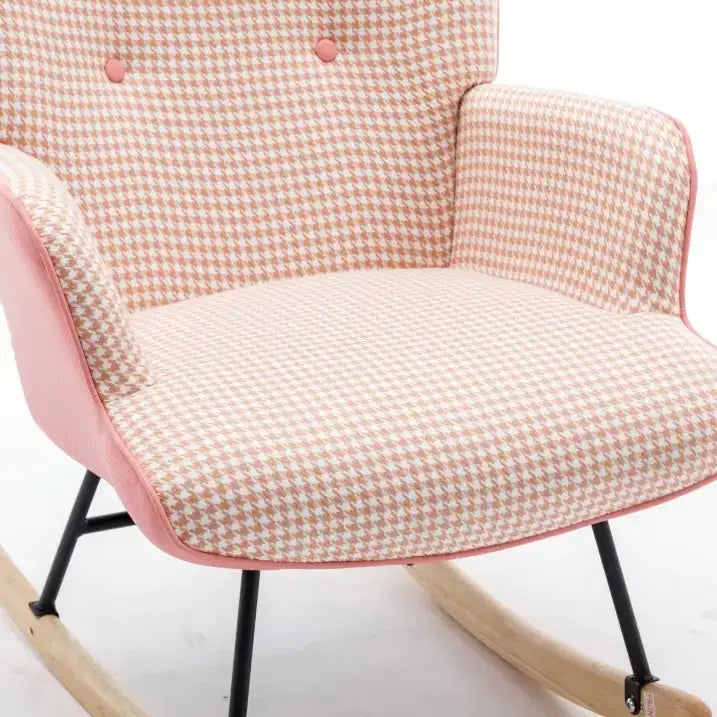 A pink and white houndstooth patterned rocking chair with black metal legs and wooden rockers.