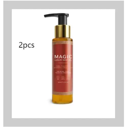 Golden pump bottle of magic luxury body oil with amber-colored liquid and a black pump top.