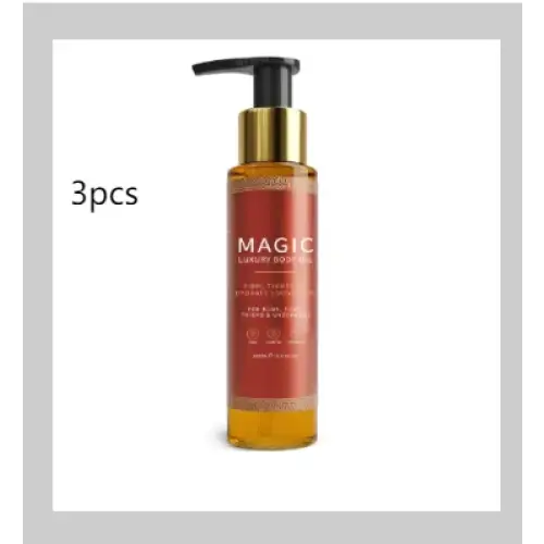 A sleek amber glass bottle with a gold pump and black cap, labeled ’magic luxury body oil’ in elegant white lettering.