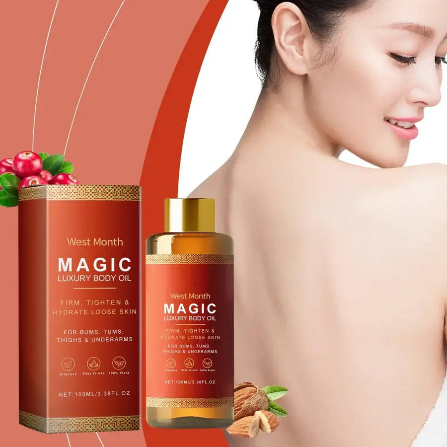 West month magic luxury body oil in a sleek amber glass bottle with gold cap and matching red box, featuring botanical accents of cranberries and almonds.