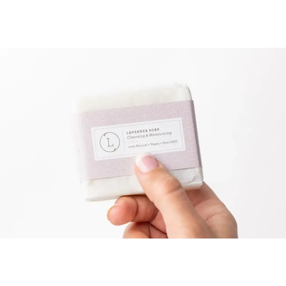 A lavender-scented, rectangular bar of soap wrapped in soft lilac paper with a minimalist label.