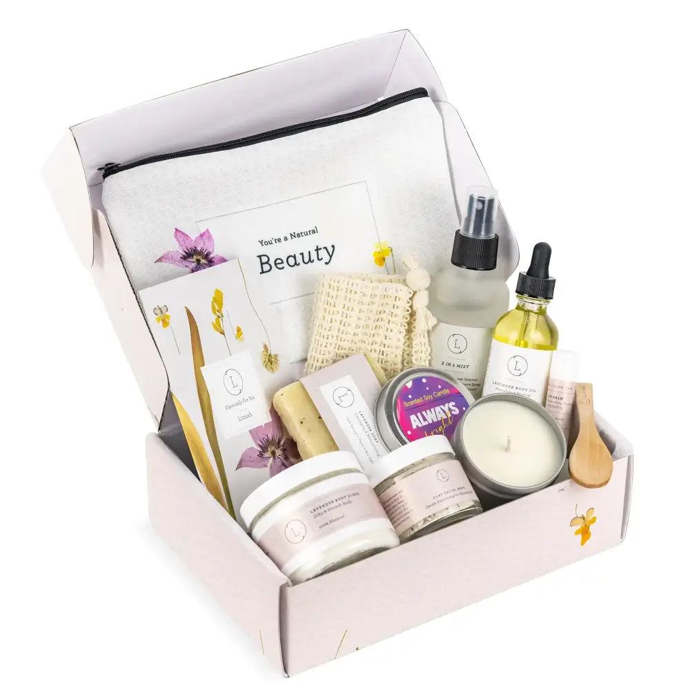 A lavender-scented candle with a smooth white wax surface and a single wick, nestled in a minimalist gift box alongside natural beauty products.
