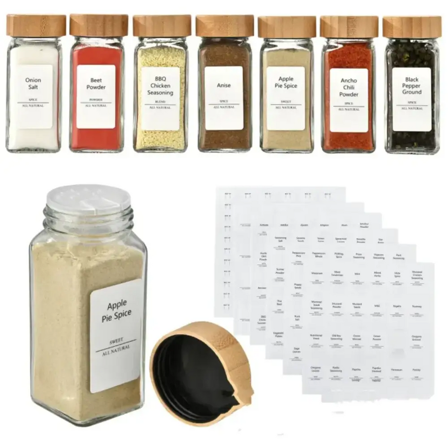 Clear glass spice jar with a wooden lid and white label reading ’apple pie spice’ containing light brown powder.