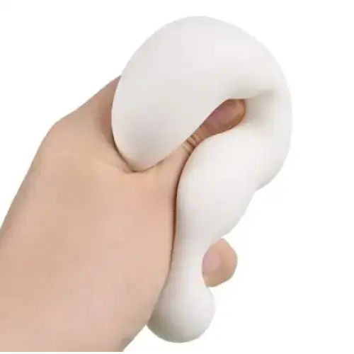 A soft, white, squishy stress ball with a smooth, slightly glossy surface and an organic, curved shape.