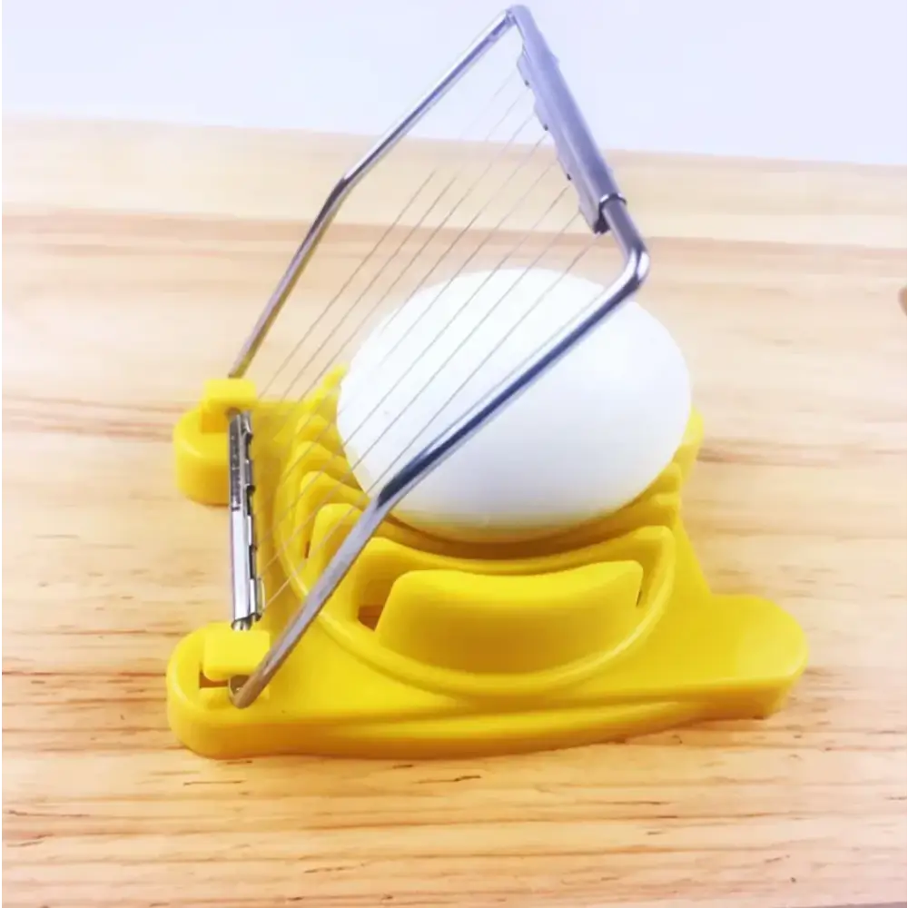 Yellow plastic egg slicer with a metal wire frame and handle.