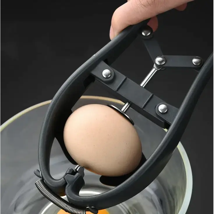 Black plastic egg cracker with silver metal components holding a brown egg over a pot.