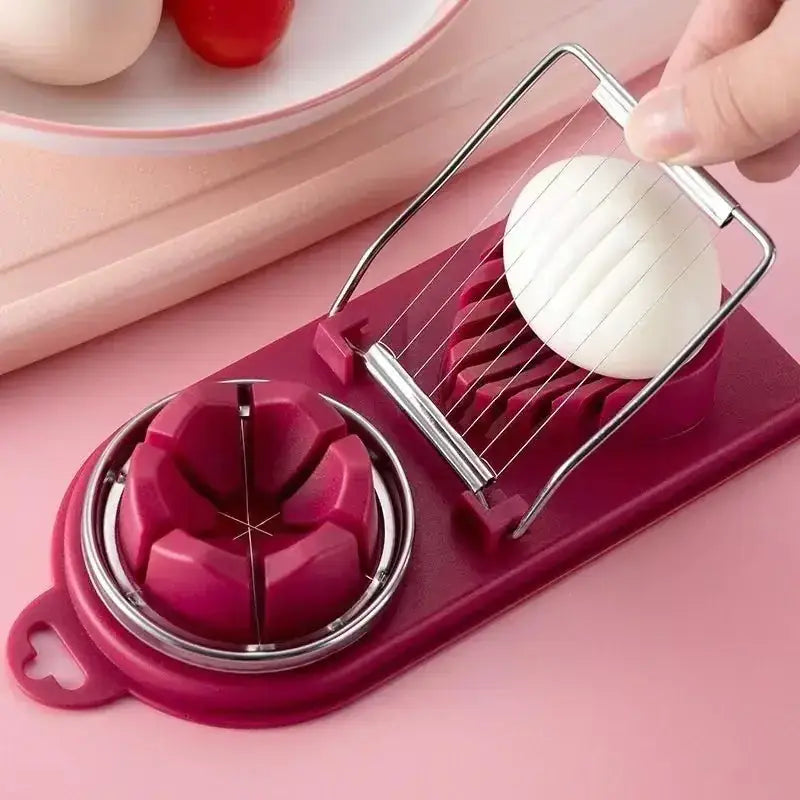 A maroon plastic and stainless steel egg slicer with a wire-cutting mechanism for slicing eggs into wedges.