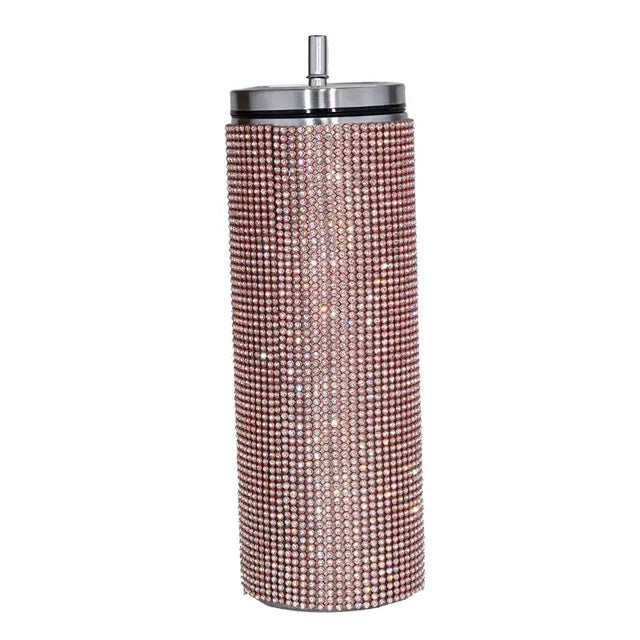 A rose gold rhinestone-encrusted stainless steel tumbler with a silver lid and straw.