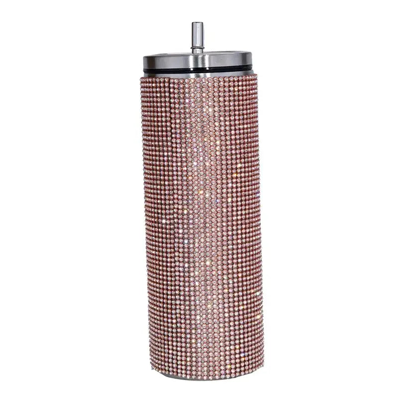 A rose gold rhinestone-encrusted stainless steel tumbler with a silver lid and straw.