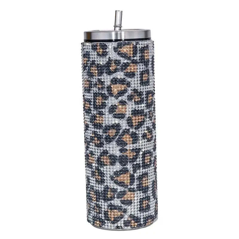 A sleek, tall insulated tumbler adorned with a sparkling leopard print pattern made of rhinestones and featuring a stainless steel lid and straw.