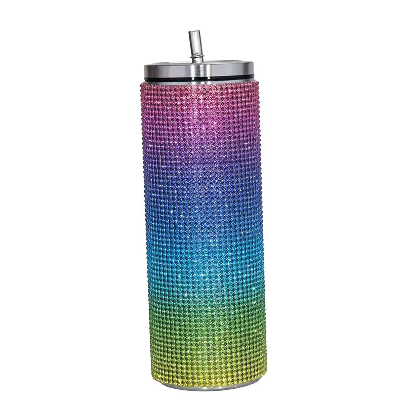 A tall, rainbow-gradient rhinestone-encrusted insulated tumbler with a stainless steel lid and straw.