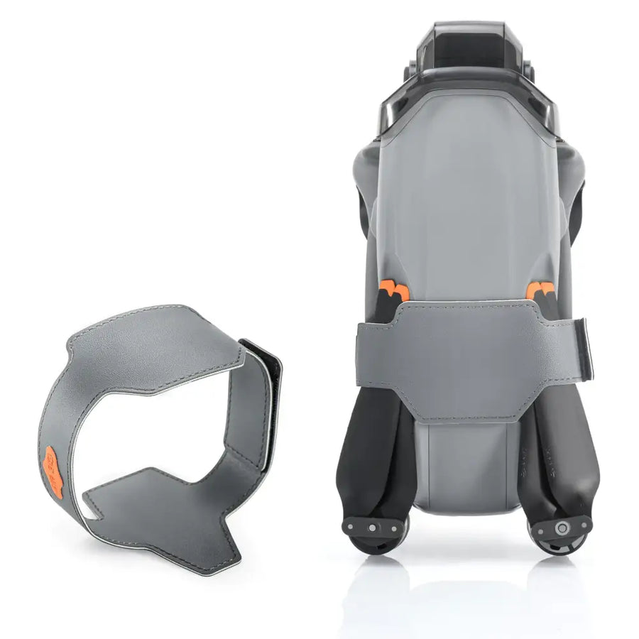 Gray leather drone carrying case with orange accent details and a matching strap.