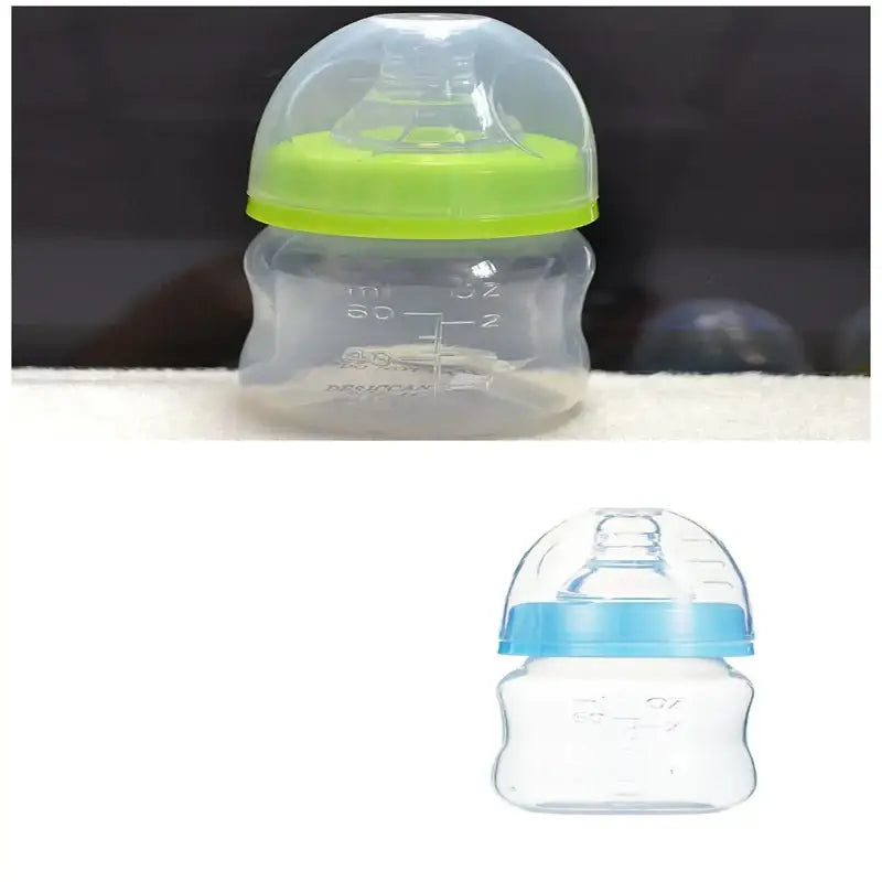 Clear plastic baby bottle with a bright green silicone nipple cover and measurement markings on the side.
