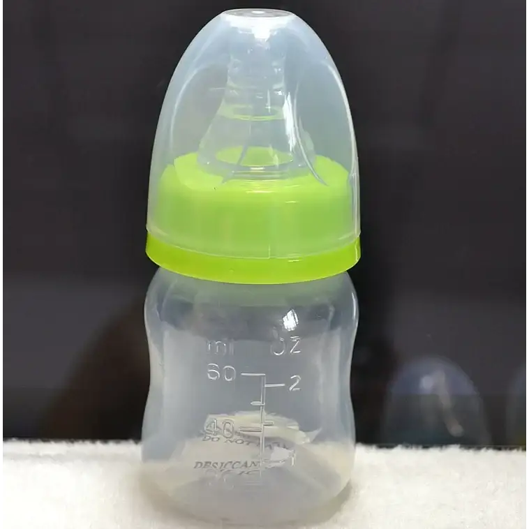 Clear plastic baby bottle with a bright lime green screw-on ring and transparent nipple cover, featuring measurement markings in milliliters and ounces.