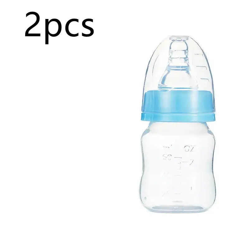 Clear plastic baby bottle with a light blue screw-on cap and matching nipple cover.