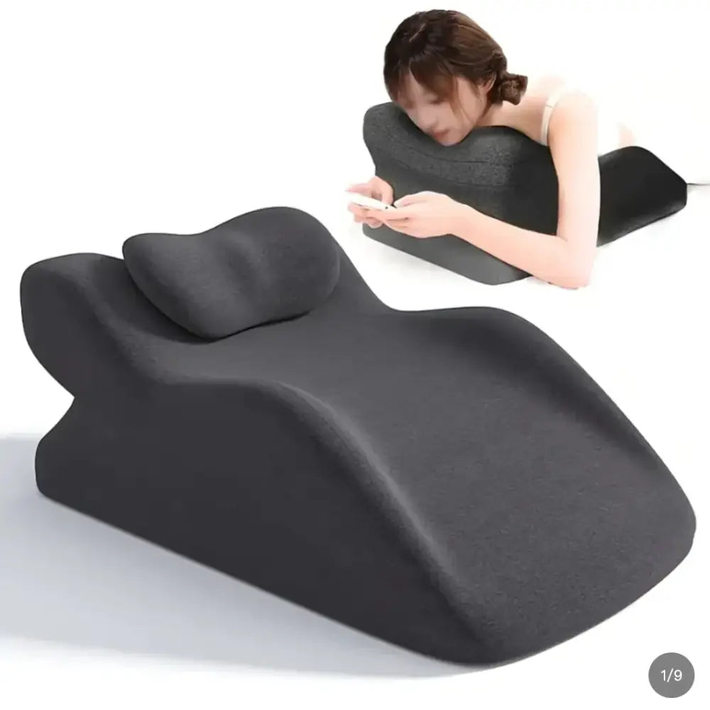 Black ergonomic neck and back support pillow with contoured shape for comfortable lounging or sleeping.