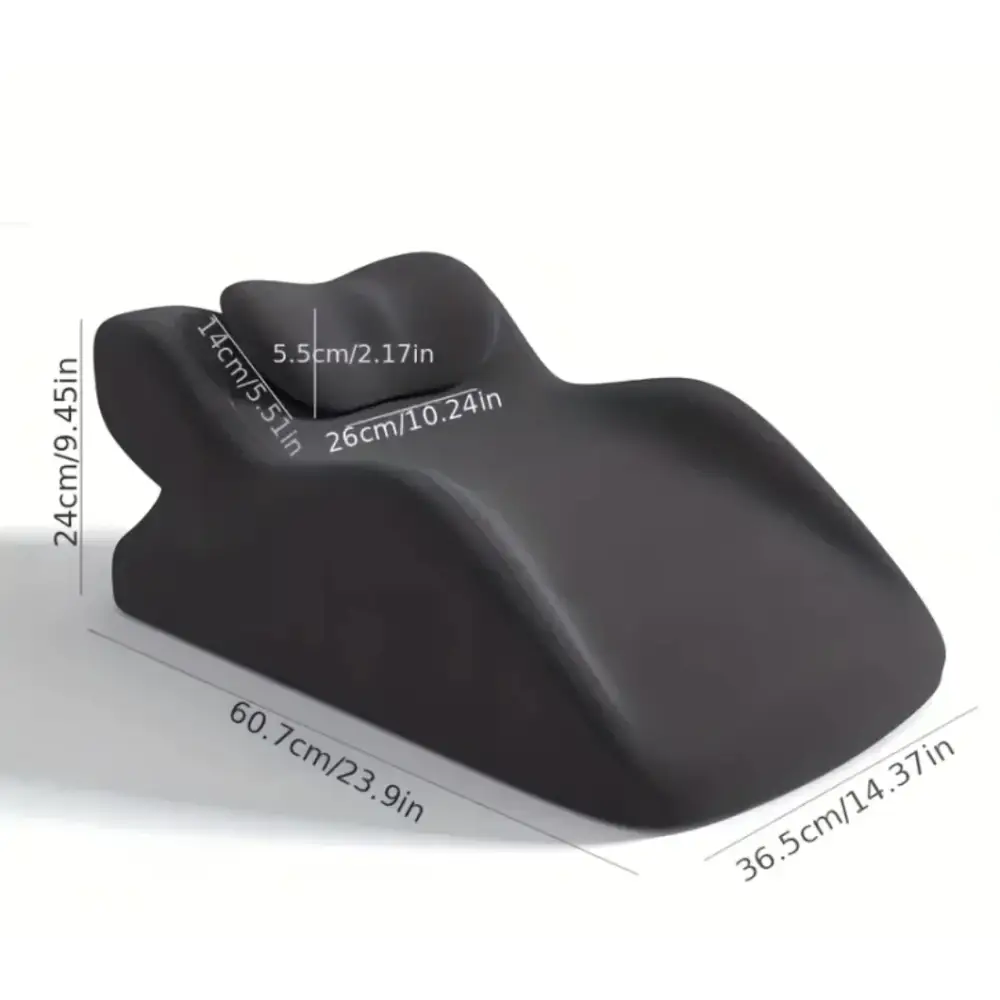 Black ergonomic lumbar support pillow with contoured shape and smooth, matte finish.
