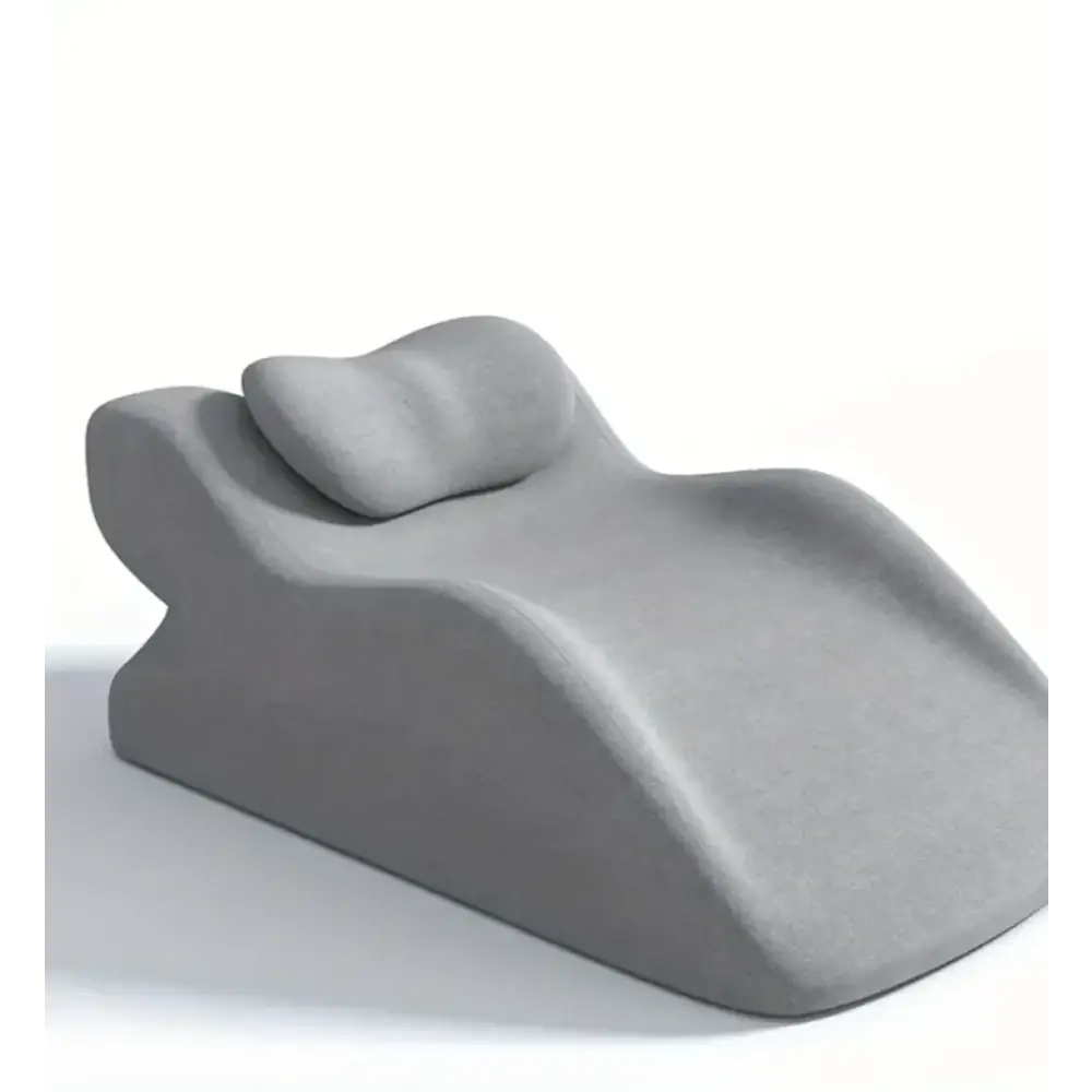 Gray ergonomic recliner with contoured shape and integrated headrest.