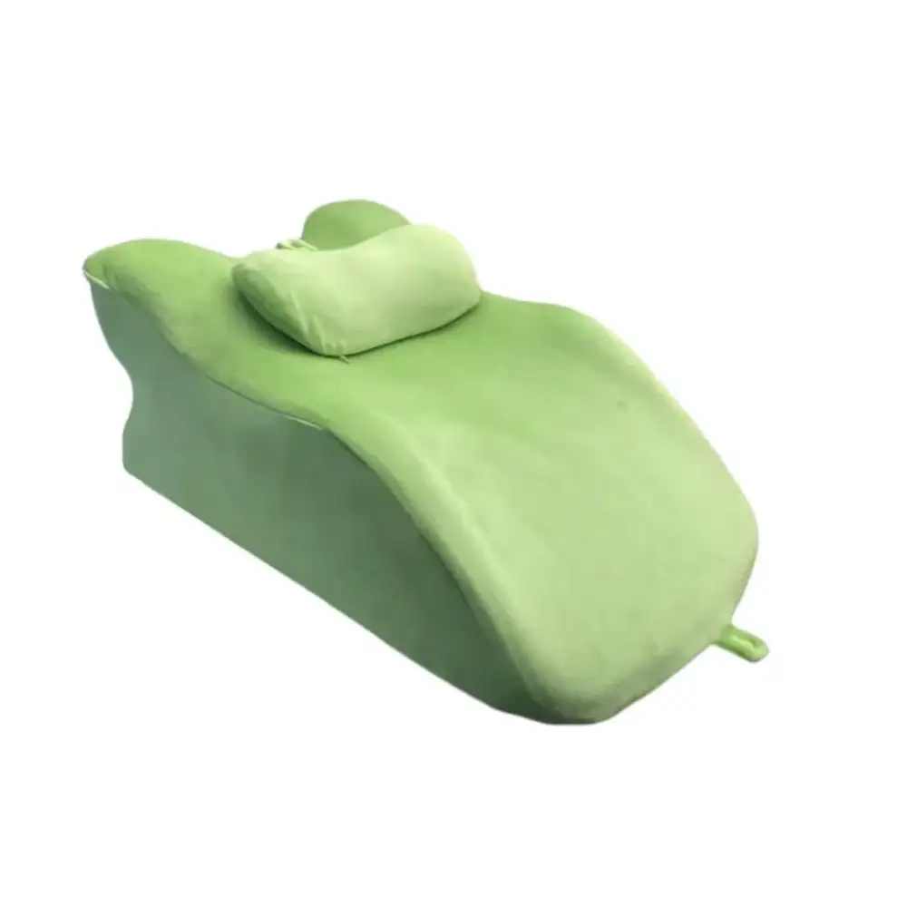 A soft, light green plush reclining lounge chair with a matching pillow.