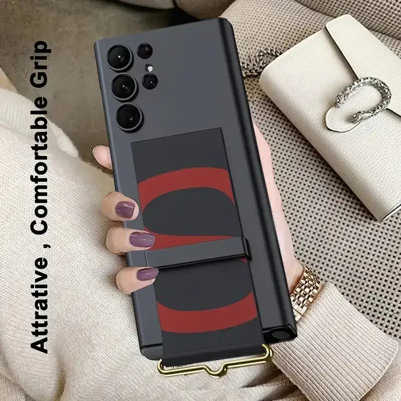 Black phone case with a red and black abstract design, featuring an integrated grip strap.