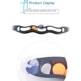 Black plastic suction cup toy with orange balls and blue accents