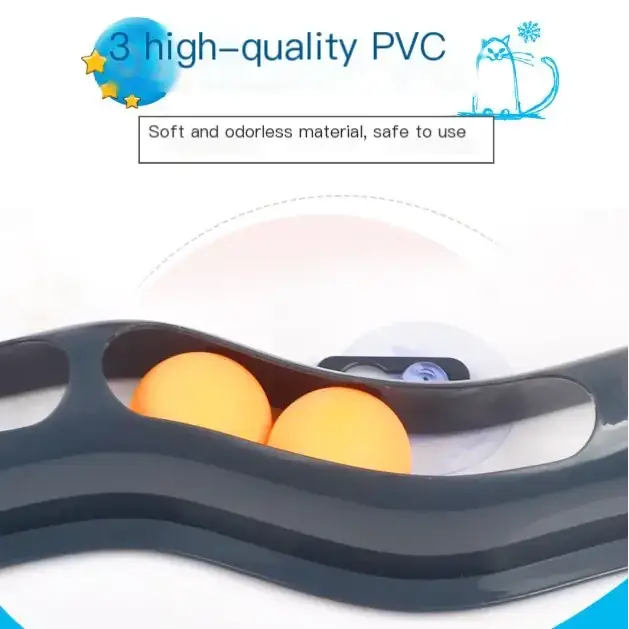 Black pvc cat toy with two orange balls nestled in its curved, wavy channels.