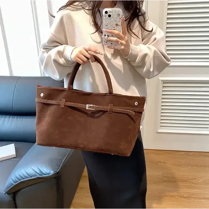 Brown suede tote bag with a central belt detail and silver-toned buckle.