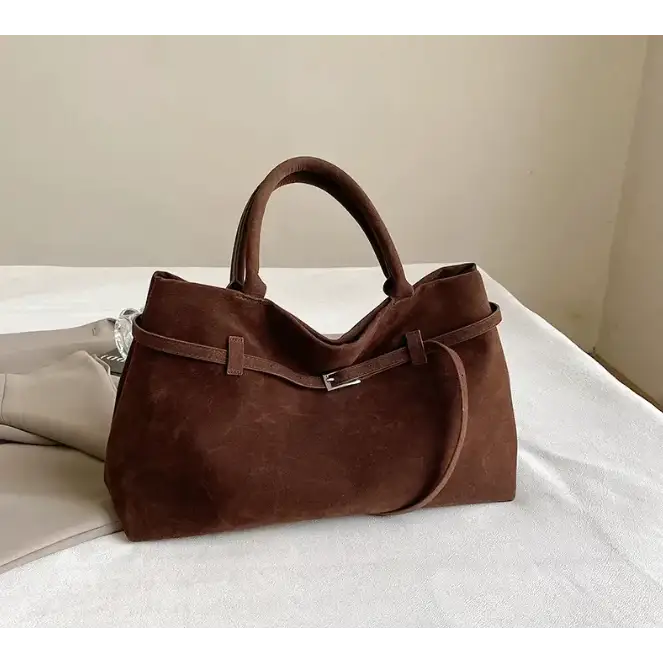 Brown suede tote bag with a silver buckle and matching handles.