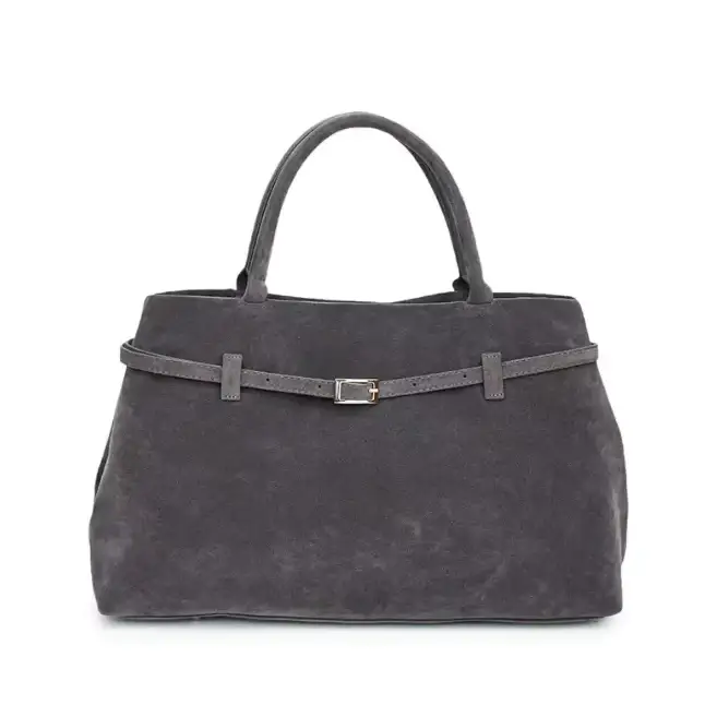A sleek, dark gray suede tote bag with a matching belt-style strap and silver-toned buckle.
