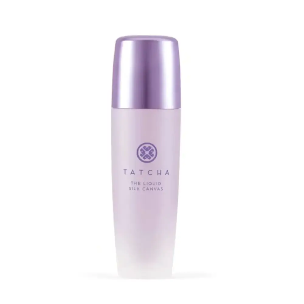 A sleek, translucent lavender bottle with a metallic silver cap and the tatcha logo prominently displayed.