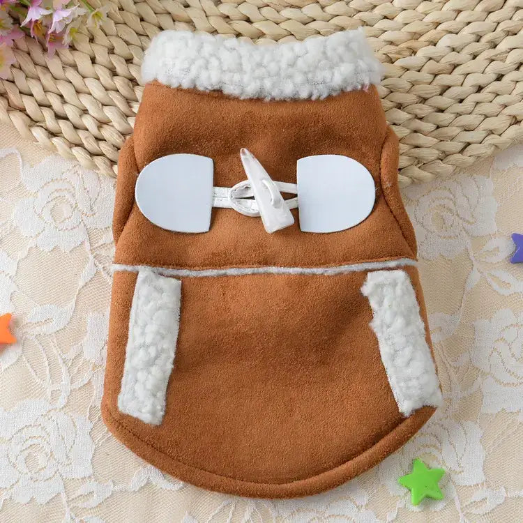 Brown suede dog coat with white faux fur trim and a white toggle closure.