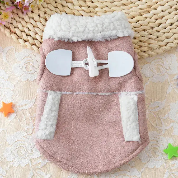 Pink faux suede dog coat with white shearling trim and matching toggle closures.