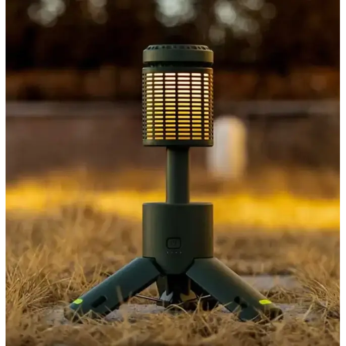 Dark green portable camping lantern with a cylindrical body featuring horizontal slats and a tripod base.