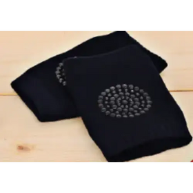 Black knee pads with a circular pattern of silver studs on the front.