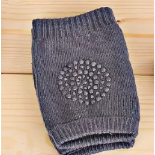 Dark gray knitted knee pad with a circular pattern of textured dots for grip.