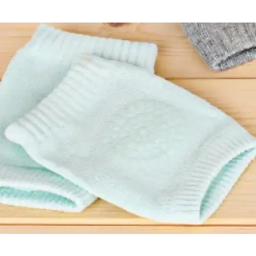 Light blue knitted knee pads with a subtle textured pattern.