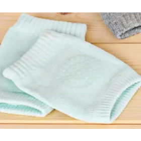 Light blue knitted knee pads with a subtle textured pattern.