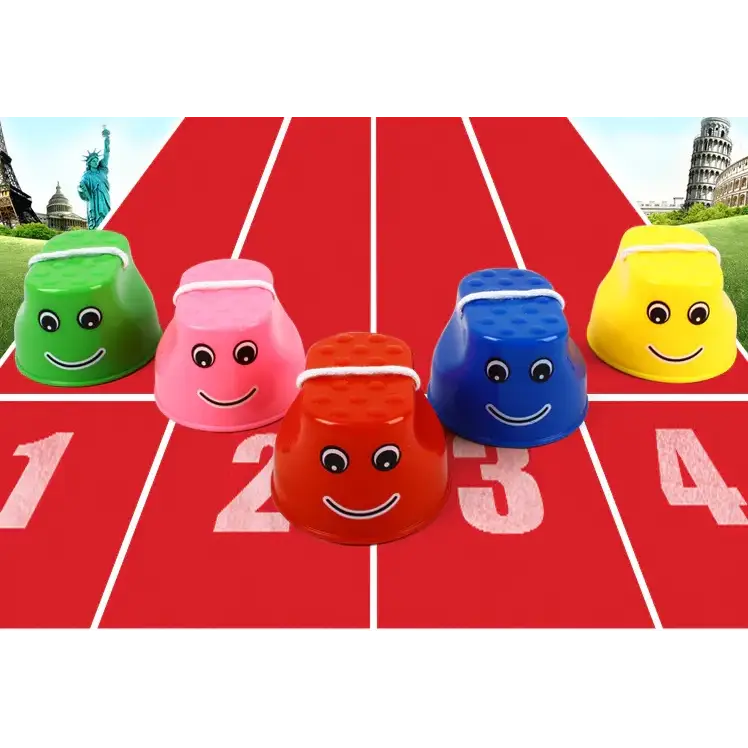 Five colorful plastic cups with smiling faces and white headbands are arranged on a red track.
