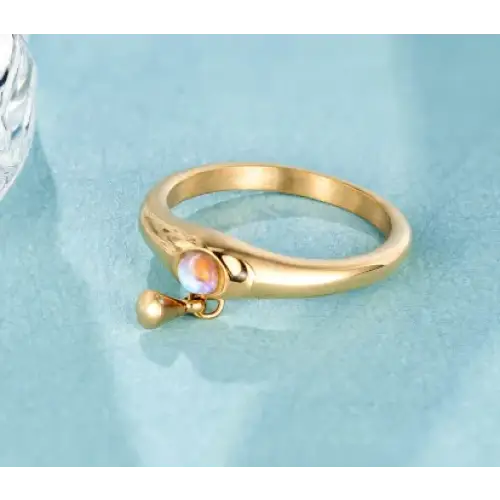 Gold-toned ring with a smooth, rounded band and a central rainbow opal stone set in a delicate bail.
