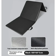 Black foldable exercise mat with a tear-resistant composite layer and anti-slip lychee pattern surface.