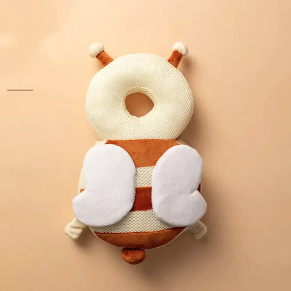 Cream and brown plush bee-shaped baby safety seat cushion with white wings.