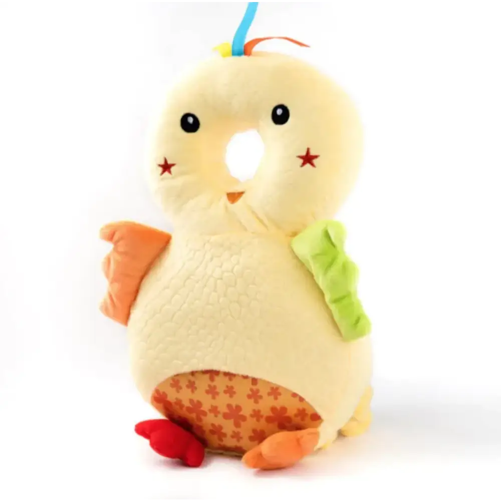 A soft, yellow plush chick toy with orange feet and wings, a green leafy accent on its back, red star markings near its eyes, and a patterned belly featuring small orange flowers.