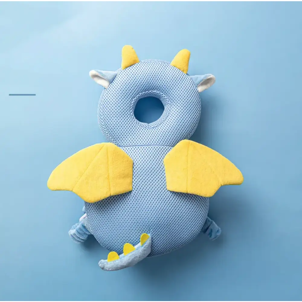 Blue dragon-shaped baby head support with yellow wings, horns, and tail details.