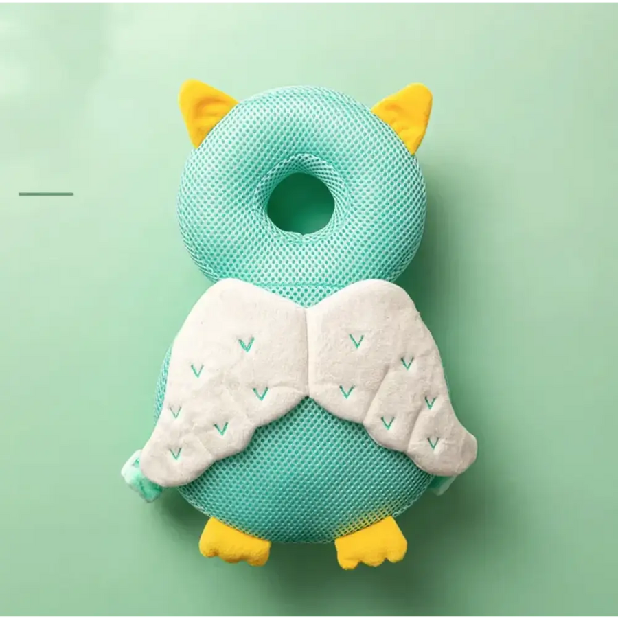 A mint green mesh owl-shaped baby head support with yellow ears, feet, and white wings embroidered with teal chevrons.
