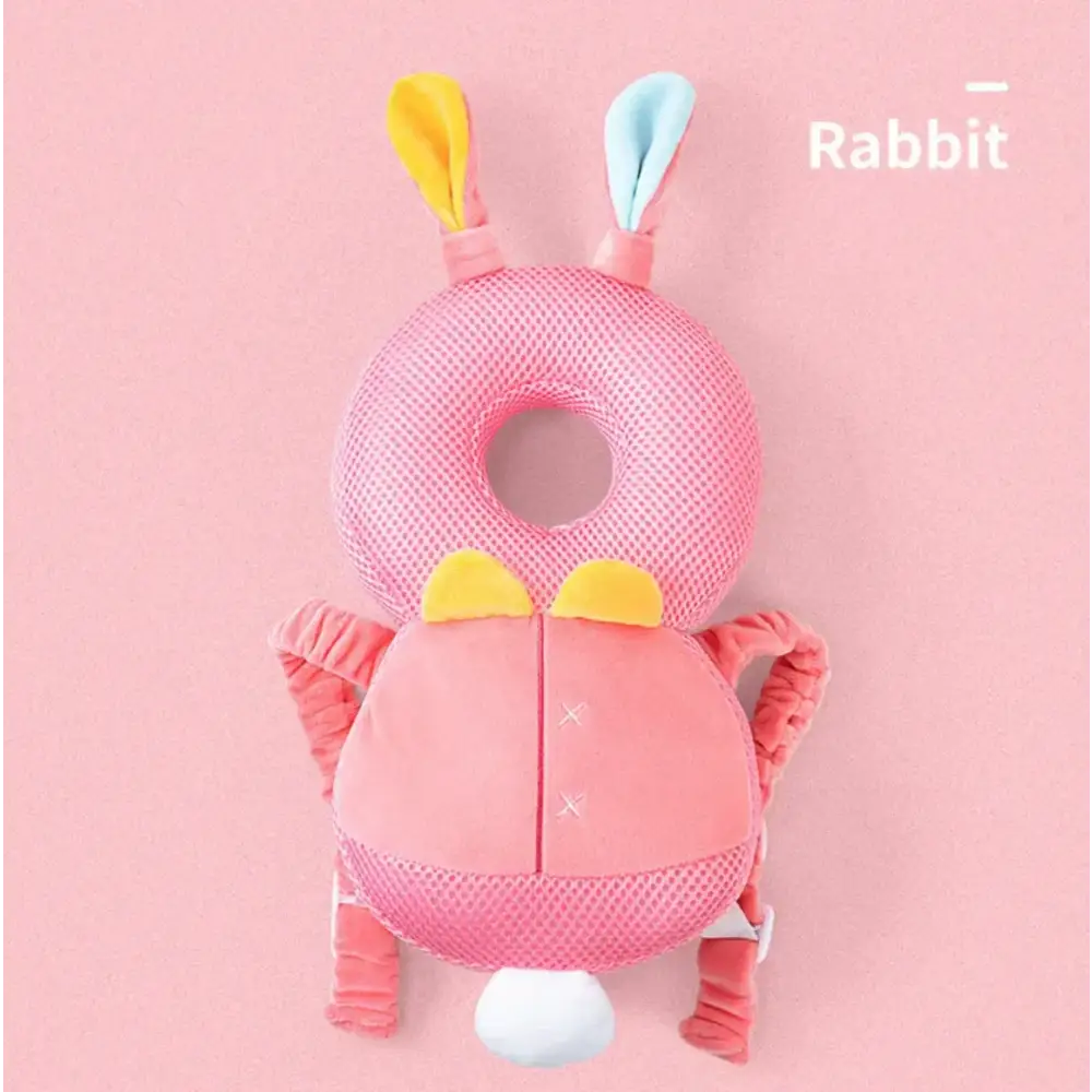 Pink mesh rabbit-shaped baby safety guard with yellow and light blue ears, a white tail, and soft fabric arms.