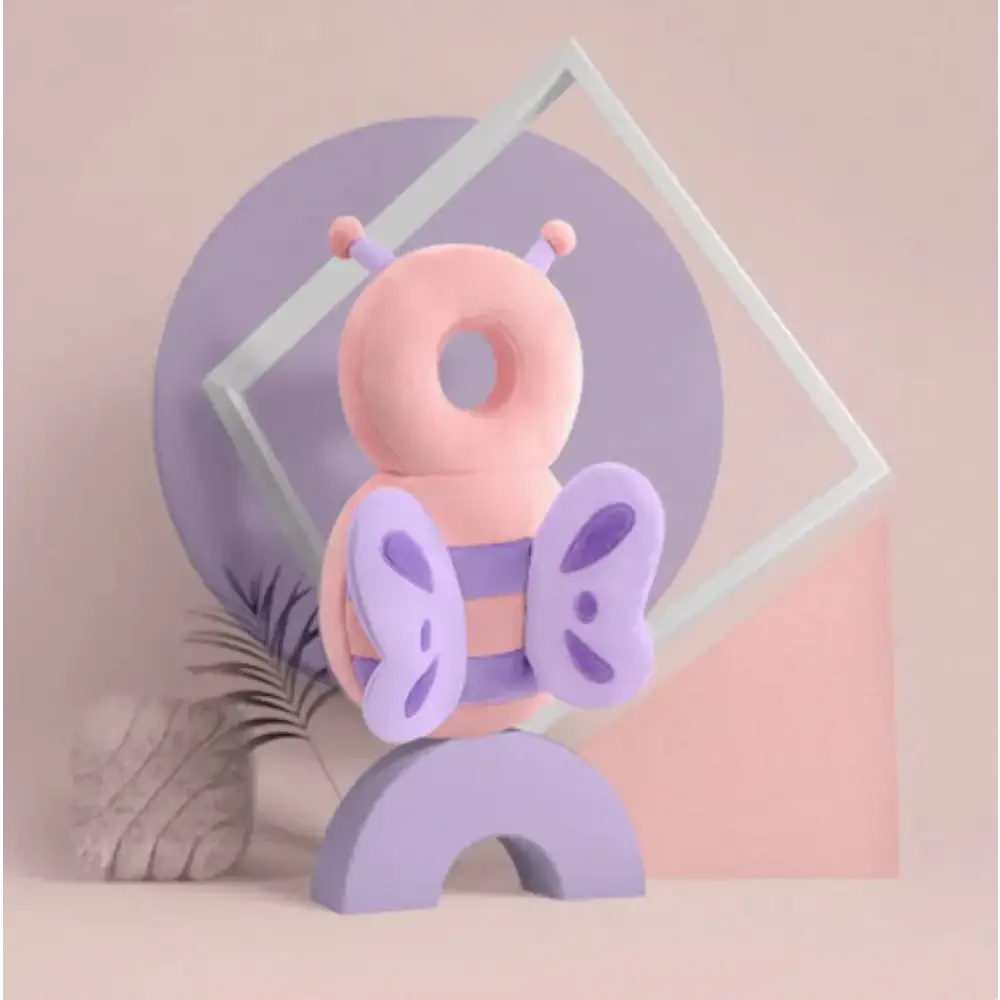 A plush, pastel pink and lavender bee-shaped toy with soft fabric wings and antennae.