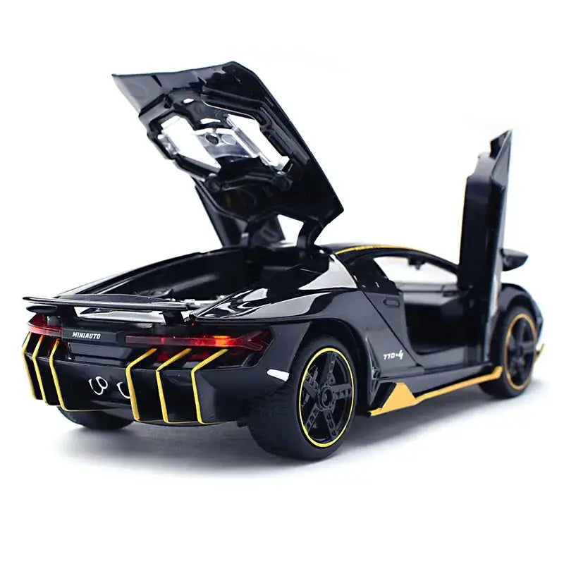 Black and gold die-cast model of a lamborghini centenario with scissor doors open.