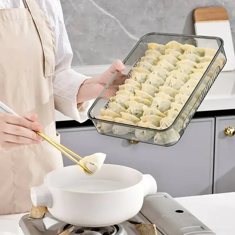 Clear glass baking dish with a black rim, filled with neatly arranged dumplings.