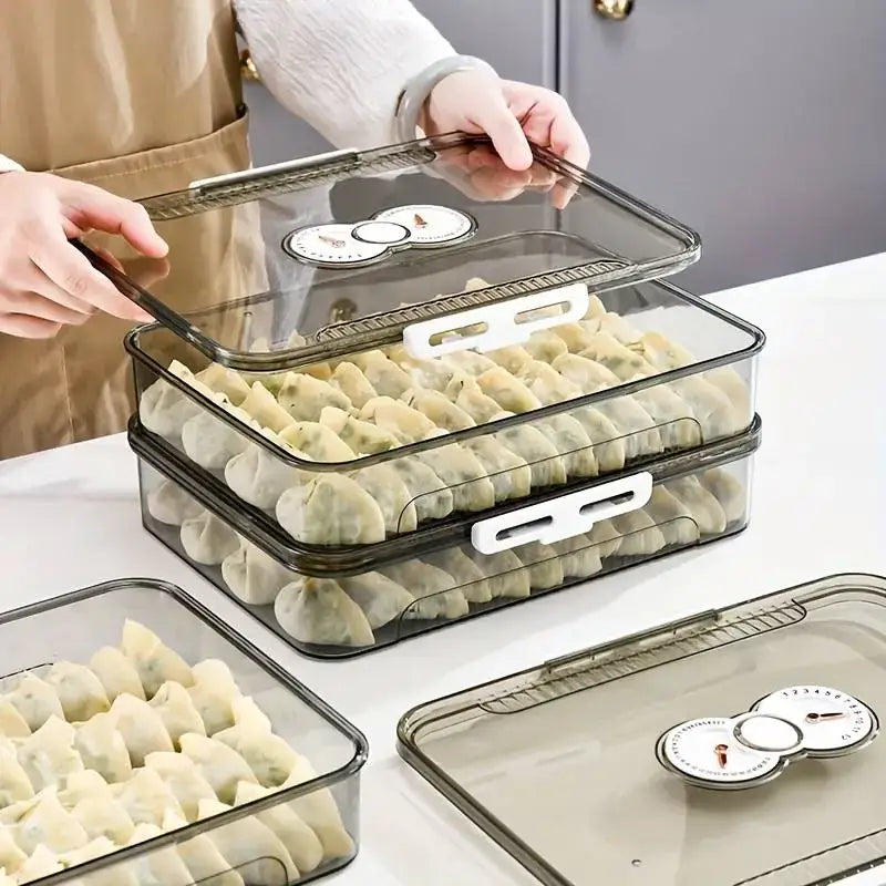 Clear plastic food storage containers with white handles and built-in temperature gauges on the lids, designed for stacking to store dumplings.