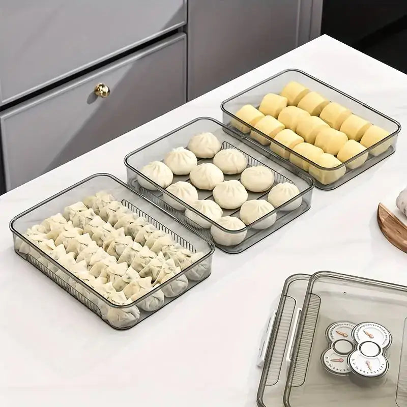 Clear plastic food storage containers with mesh bottoms, holding various types of dumplings and buns.